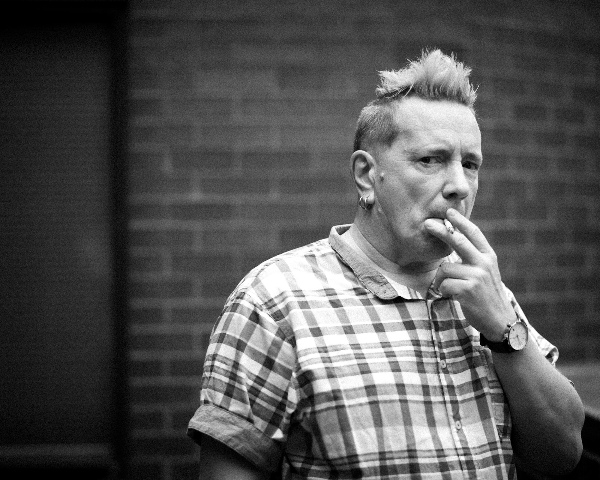 John Lydon a.k.a. Johnny Rotten, the former lead singer of the Sex Pistols was in The Current's studios for a recording session with Public Image Ltd. Between takes John and his tour manager went for a cigarette break on our 4th floor balcony. I followed to just shoot some candid shots with the nice overcast light. After ignoring me for the first few minutes while I snapped away, Johnny gave me this intense look. I knew immediately I had "the shot" of the day, just an iconic F--- off glare from this classic punk rocker.