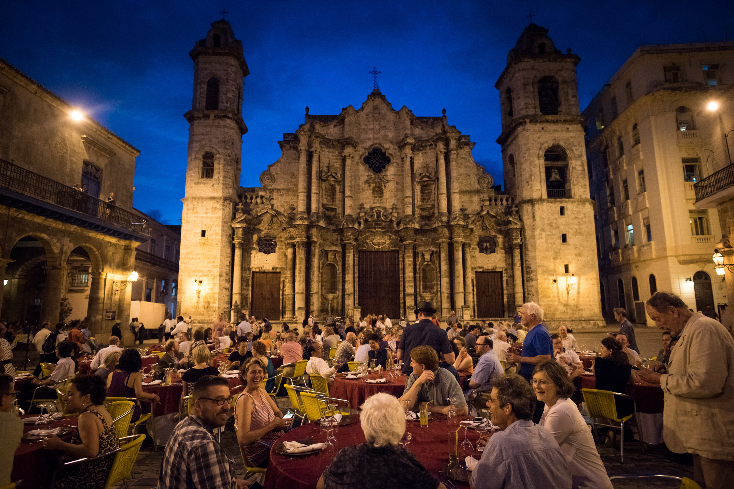 Orchestra members enjoy a dinner served in the Plaza de la Catedral in the center of Old Havana, Cuba. 