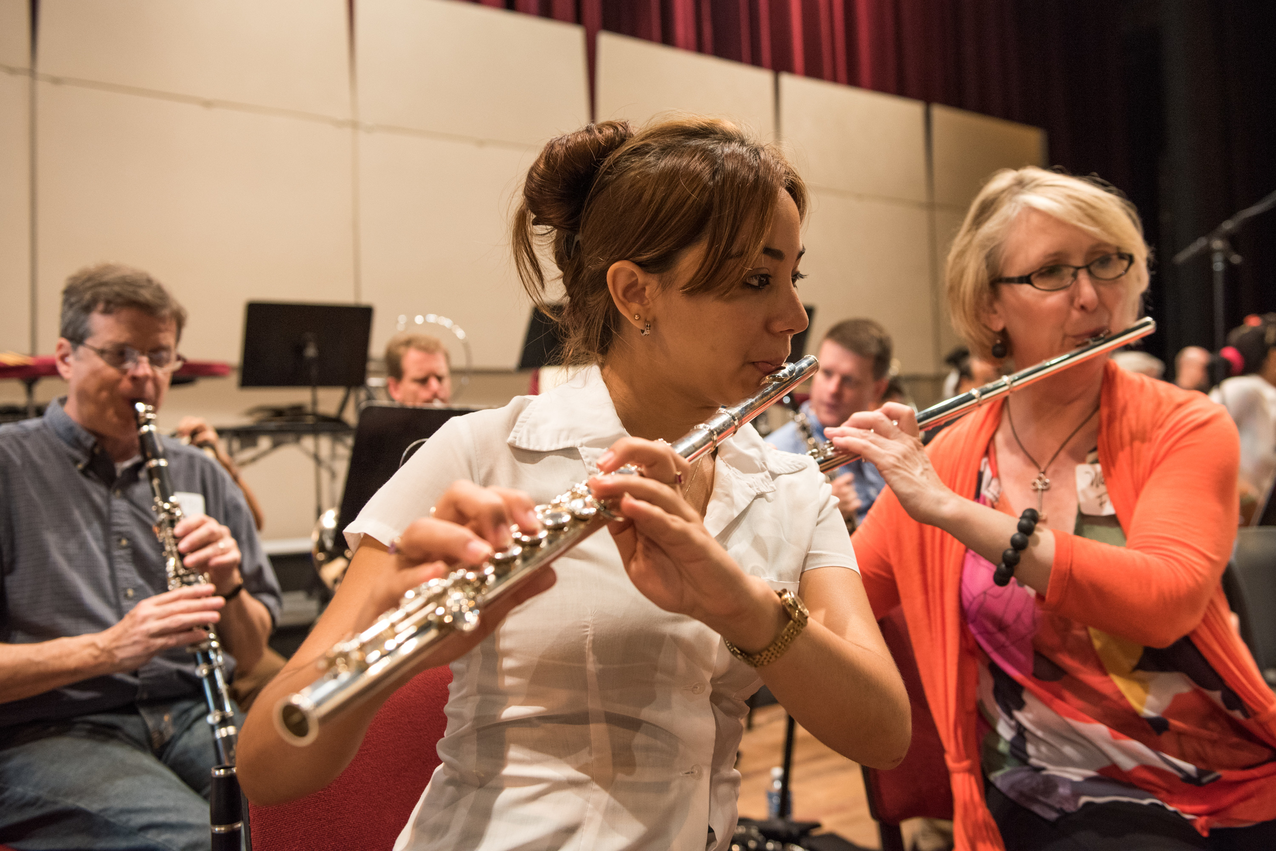 A student from the national youth symphony sits right next to flutist Wendy Williams, as part of a side by side rehearsal, where orchestra members paired up with members of the youth symphony for a rehearsal conducted by Osmo Vanska.