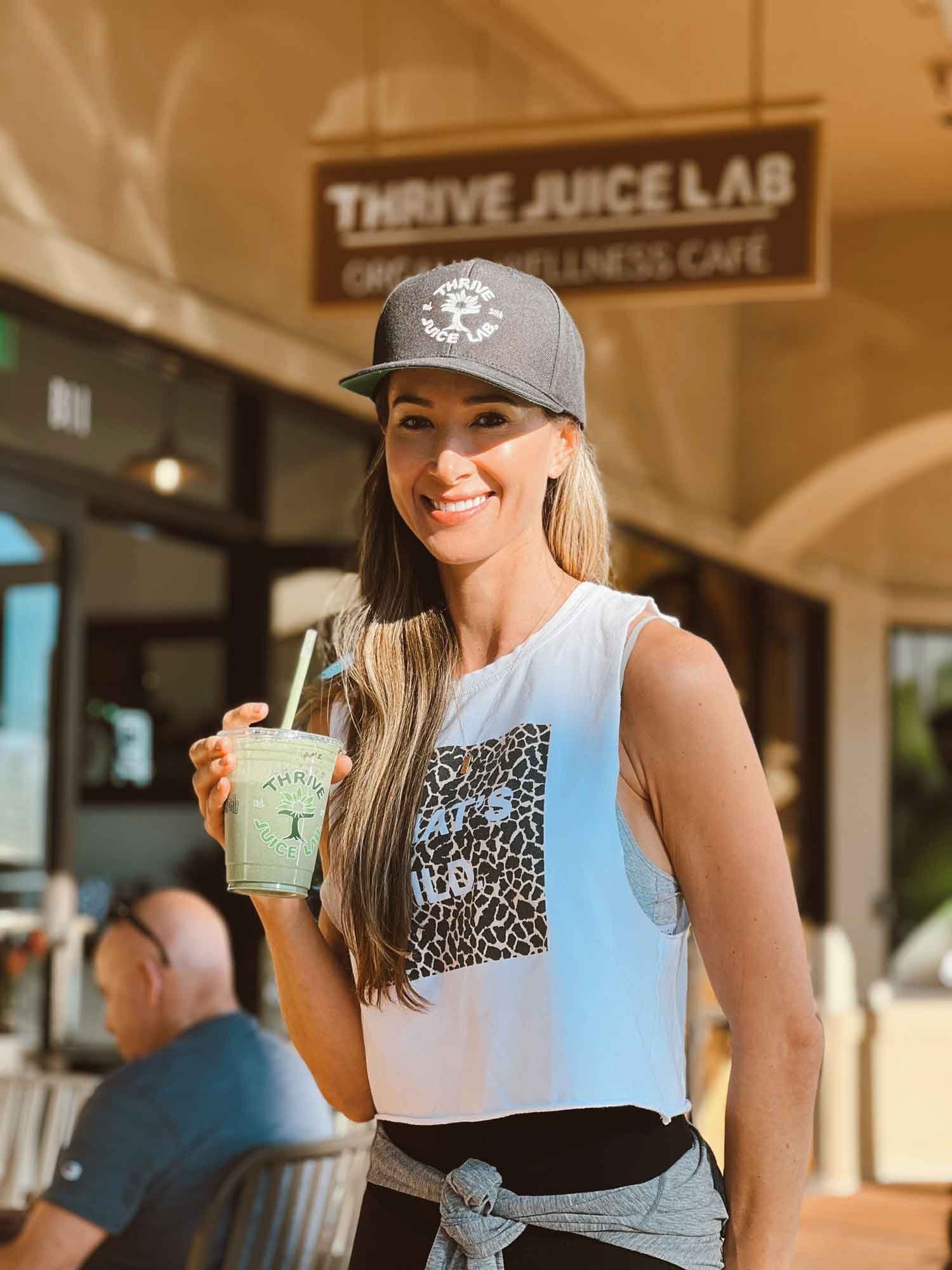 Smiling Thrive Juice Lab customer with smoothie