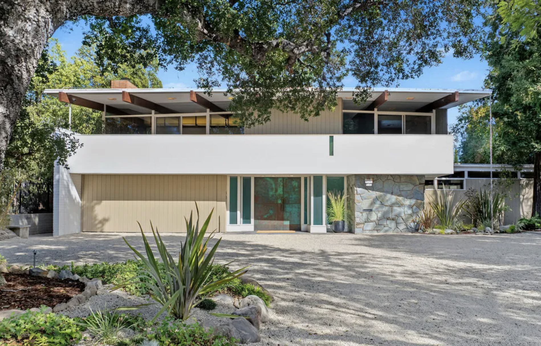 Two story 1956 flagstone and stucco modern house with a second story balcony on Armada Drive in Pasadena's Prospect Historic District