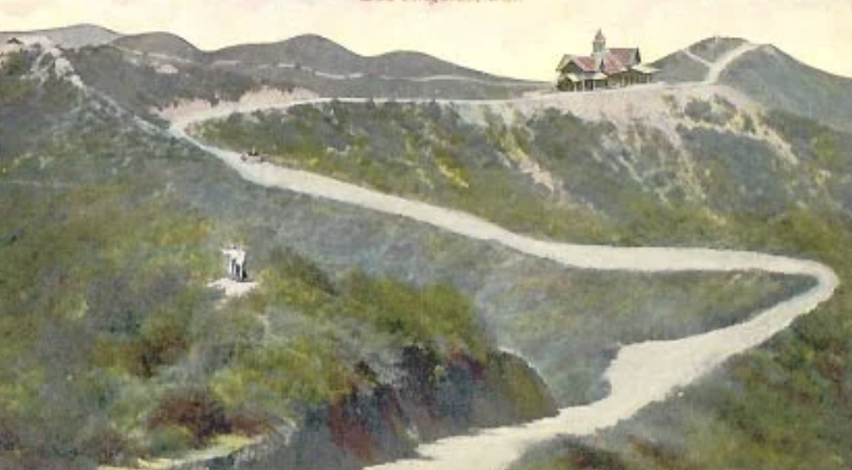 Hand-tinted postcard showing the road up Lookout Mountain in Laurel Canyon, with the Lookout Mountain Inn on the ridge, about 1910