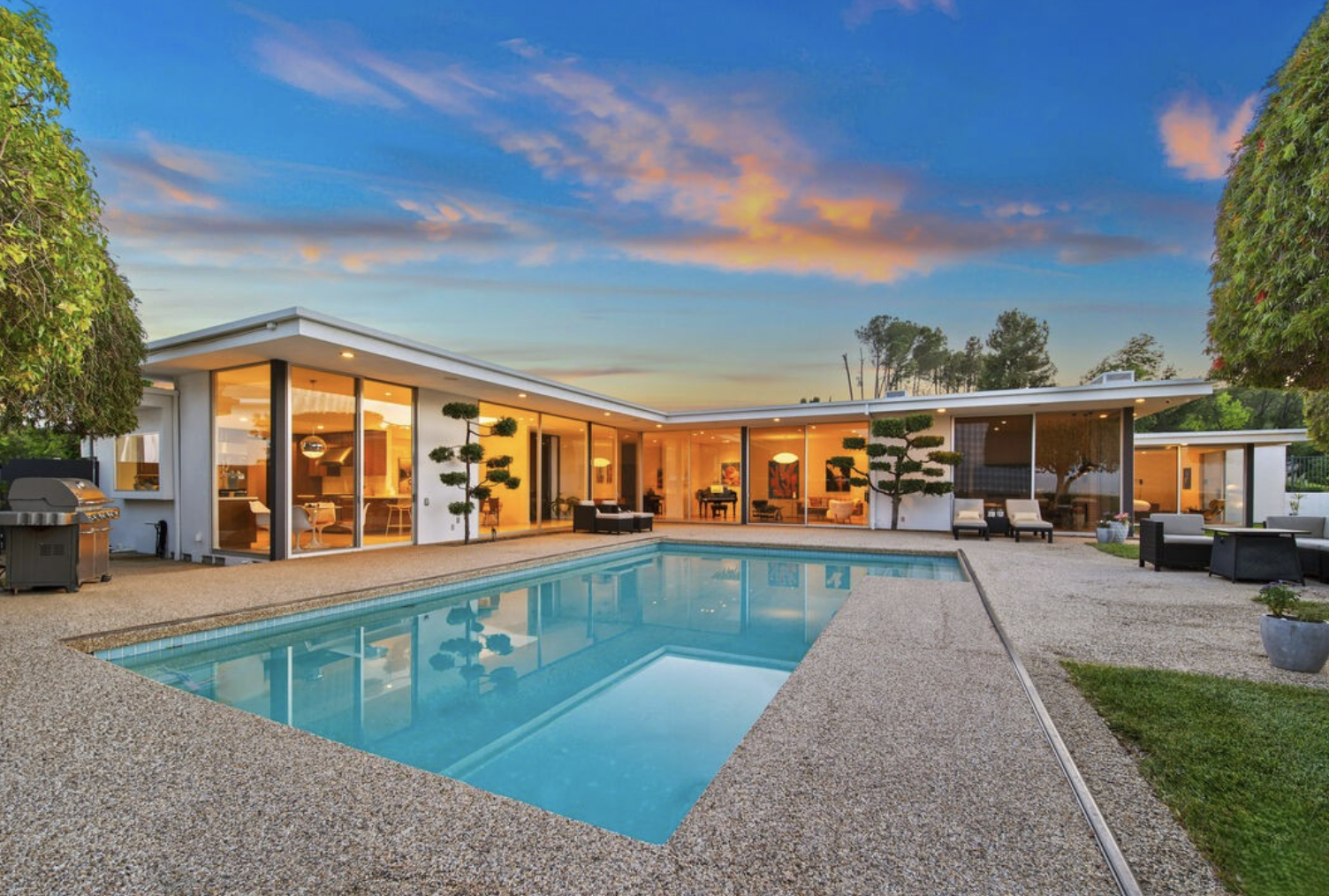 A Benton & Park mid-century modern home in Los Angeles, with a gated courtyard entry and walls of glass opening to a pool, in the firm's California modernist style.