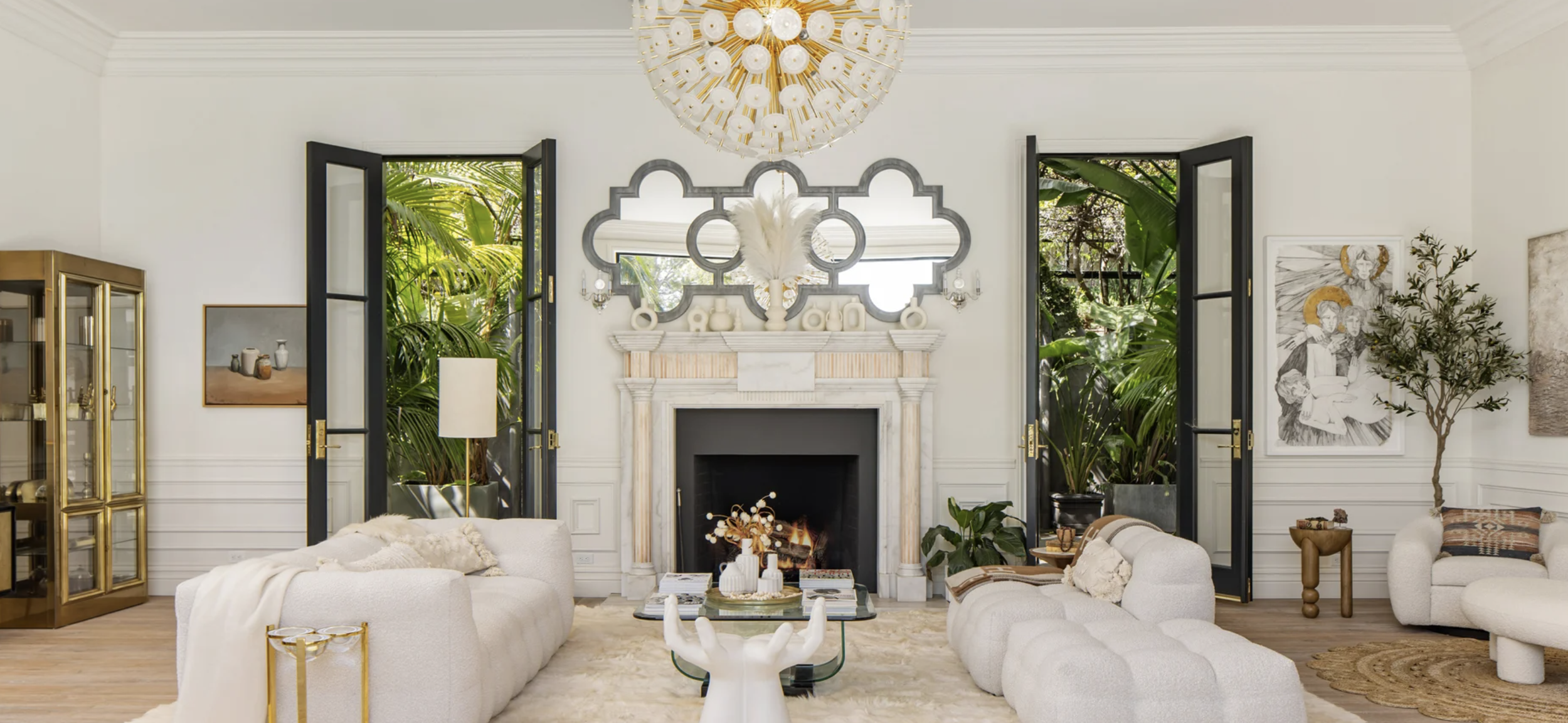 The living room of Bob Ray Offenhauser’s 1967 house at 1457 Blue Jay Way in the Bird Streets, with a marble fireplace between two pairs of French doors.