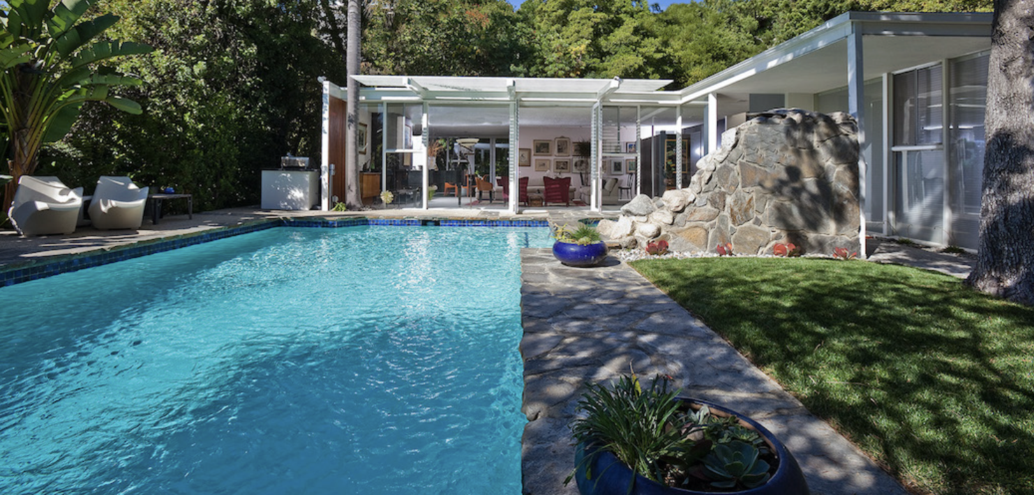 A Richard Dorman mid-century post-and-beam house in Los Angeles, with exposed wood beams and floor-to-ceiling glass.
