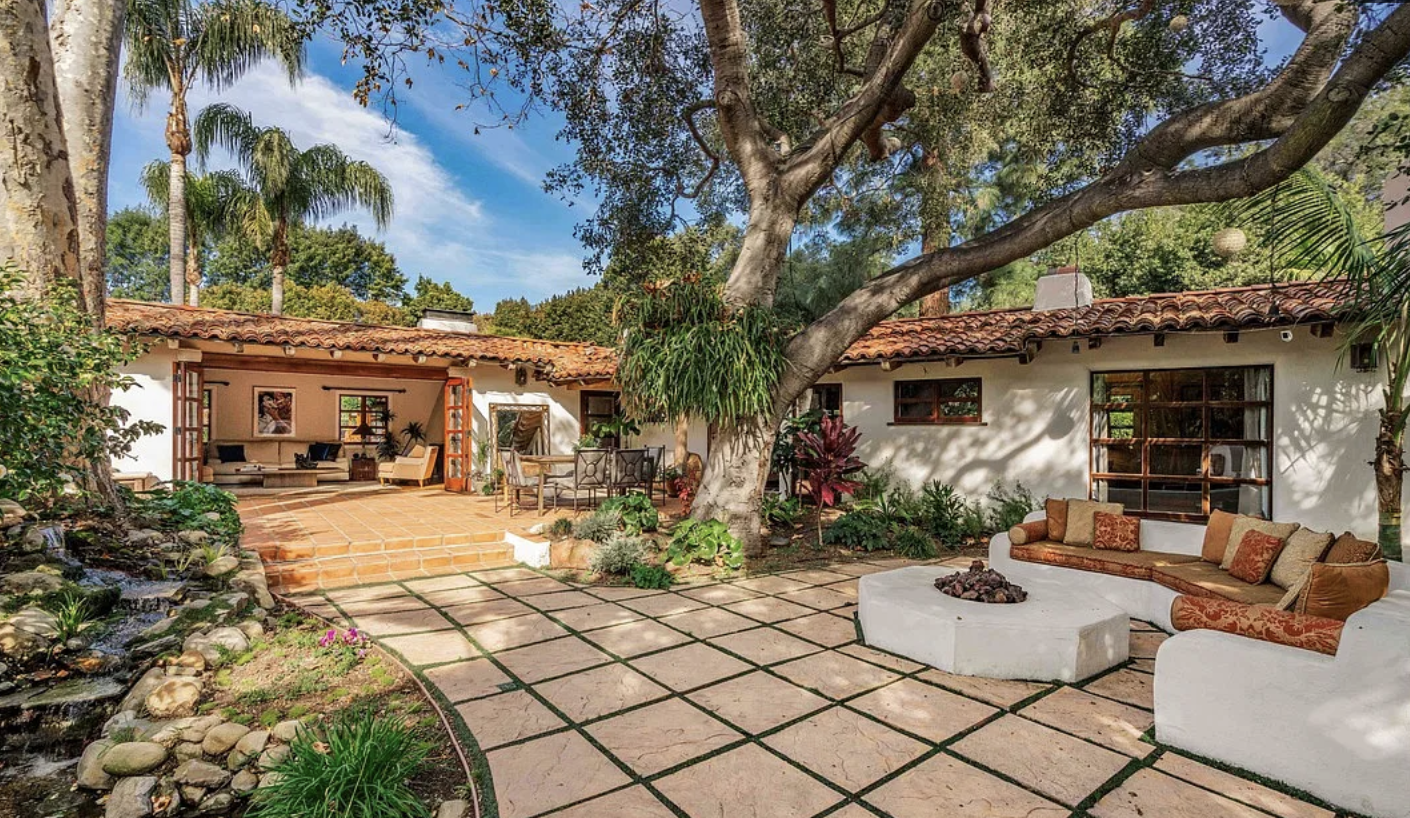 A low 1930s ranch house among sycamores on Mandeville Canyon Road in Brentwood.