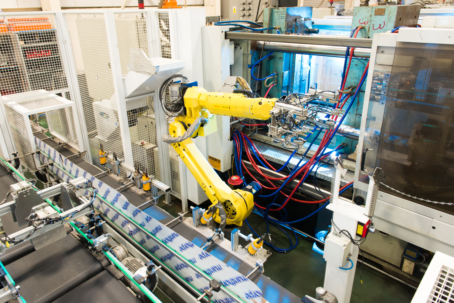 These robotic arms move incredibly fast! This one plucks a plastic part, rotates and attaches other parts, and places it in a chute for packaging.