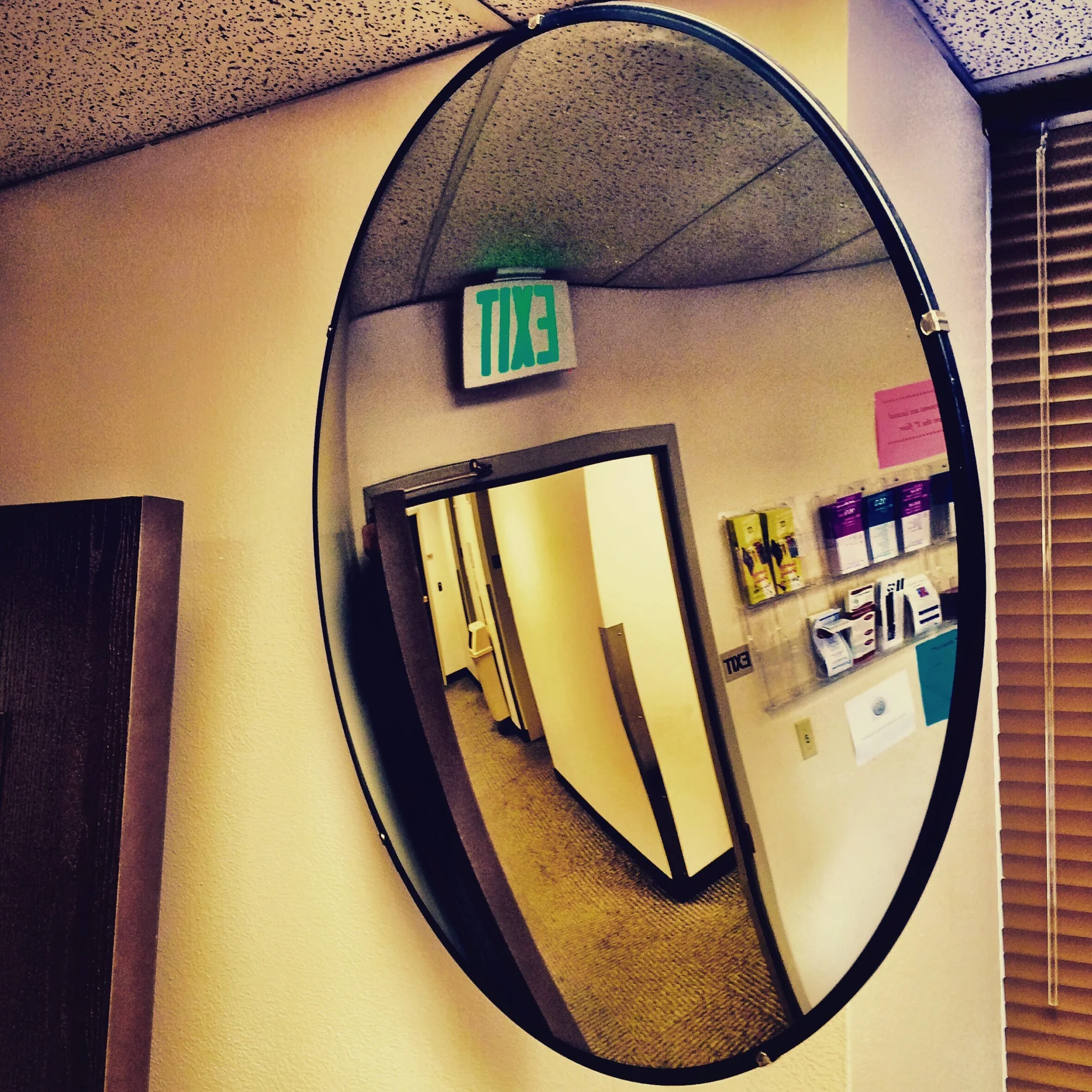 A wide angle mirror in the waiting room at the probation office