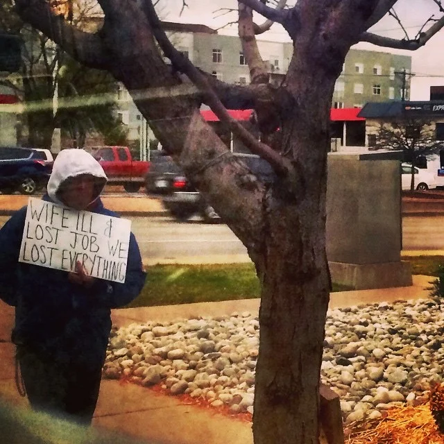 Panhandling must be one of the hardest jobs - A man holds a sign on Colorado Blvd in Denver.