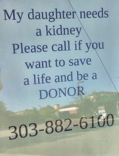 Sign in the back window of a car in the parking lot at Starbucks