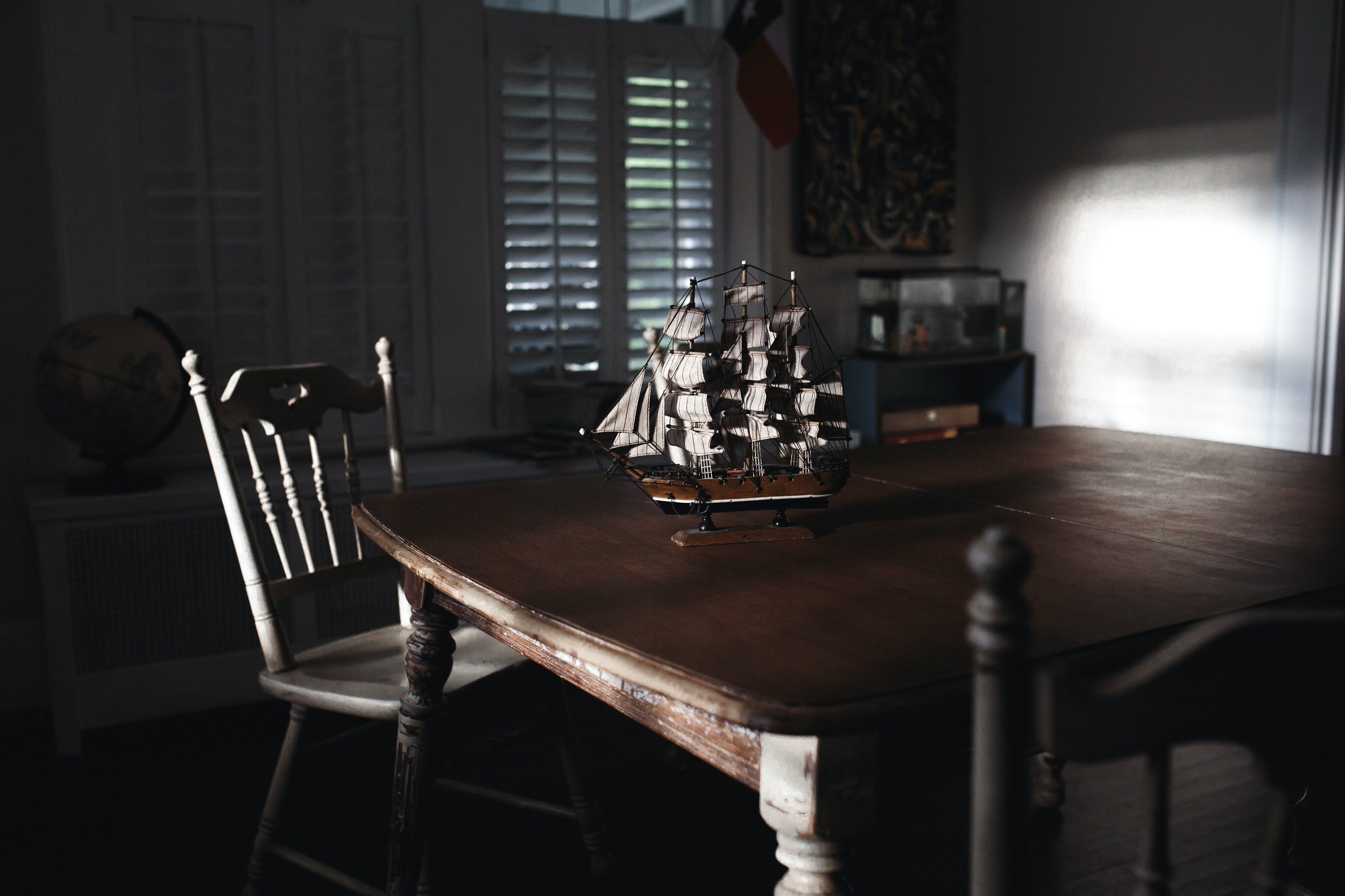 An old table with a small pirate ship on top