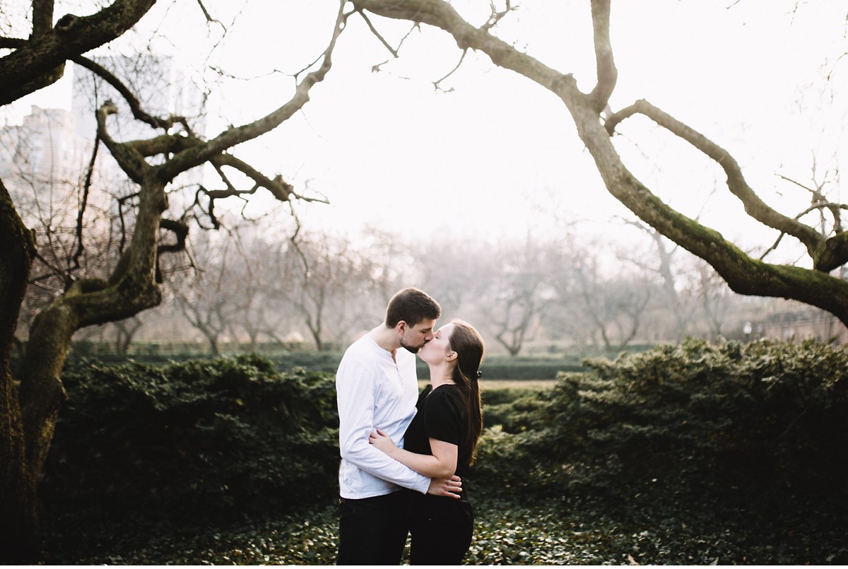 Kissing engaged couple in Conservatory Garden, NYC.