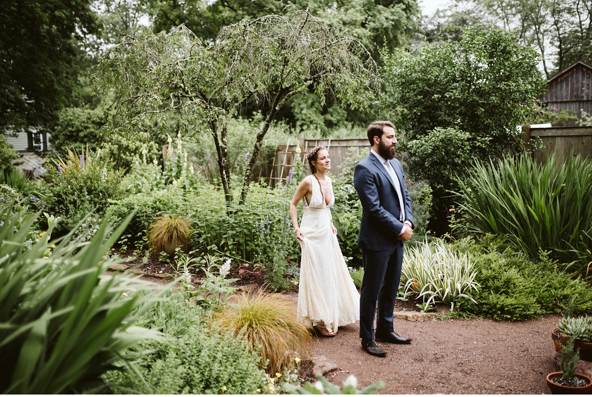 Bride walks towards groom for first look in Willowwood Arboretum-2