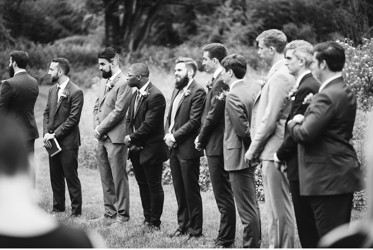 Groomsman during outdoor ceremony in black and white