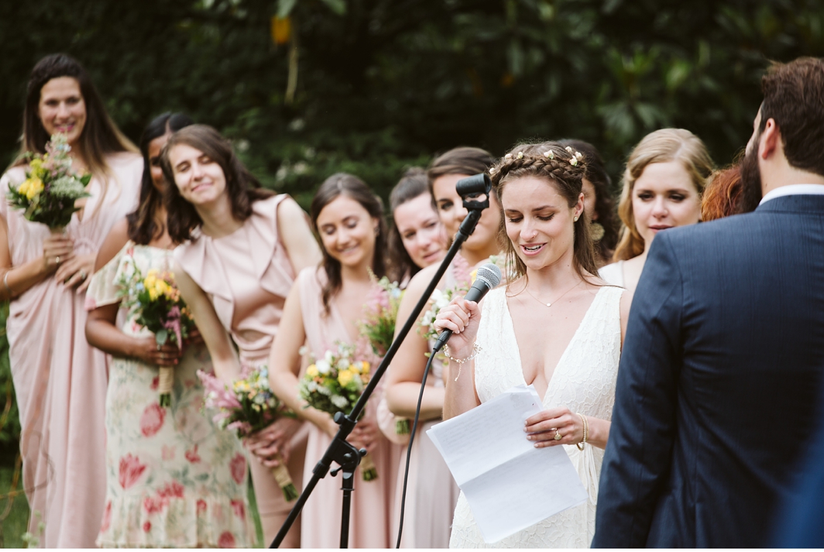 Bride reading vows during outdoor ceremony at Willowwood Arboretum