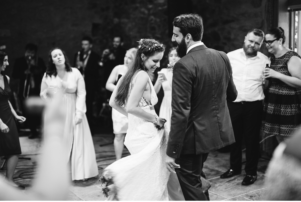 Bride and groom dancing in stone barn