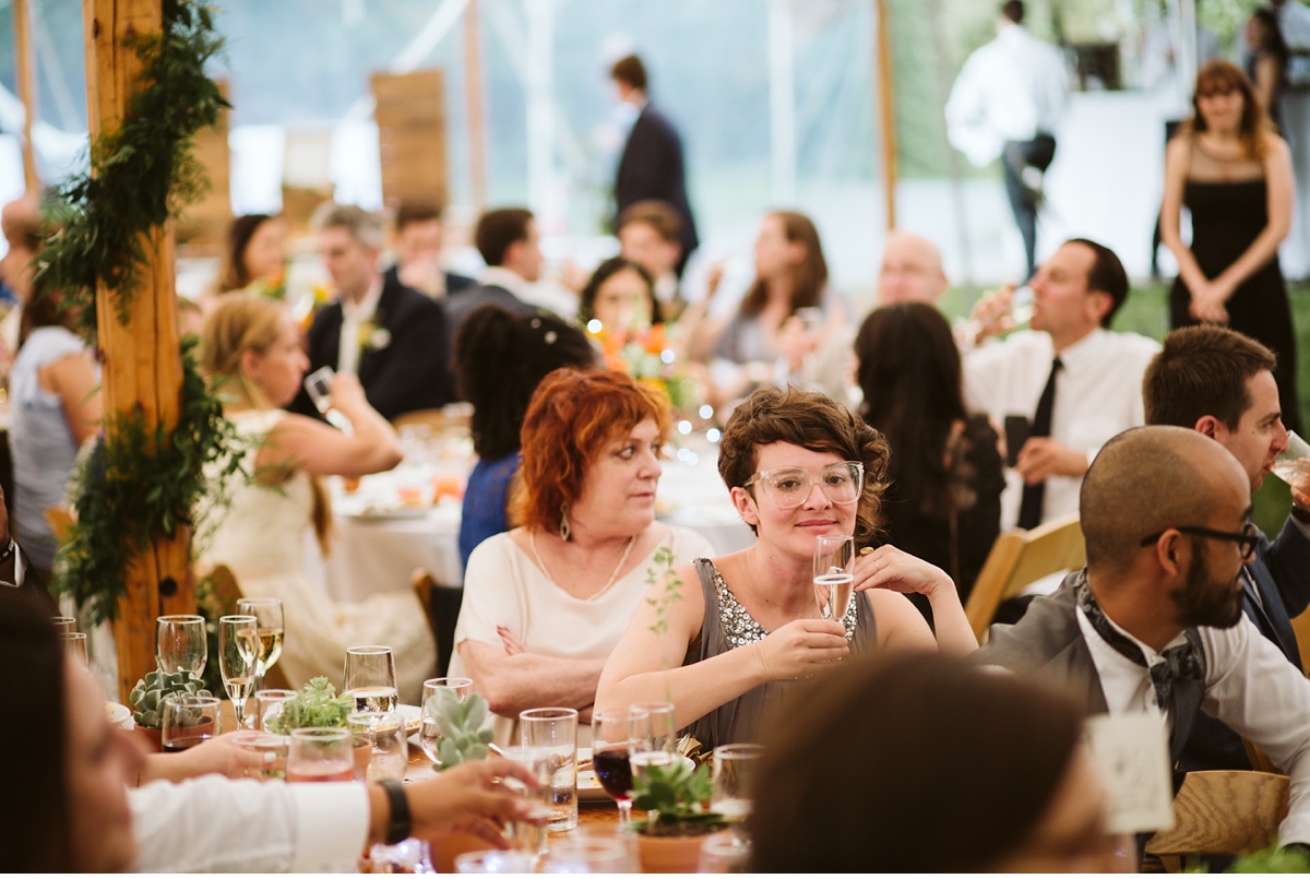 Candid of guest at tented dinner during summer wedding NJ