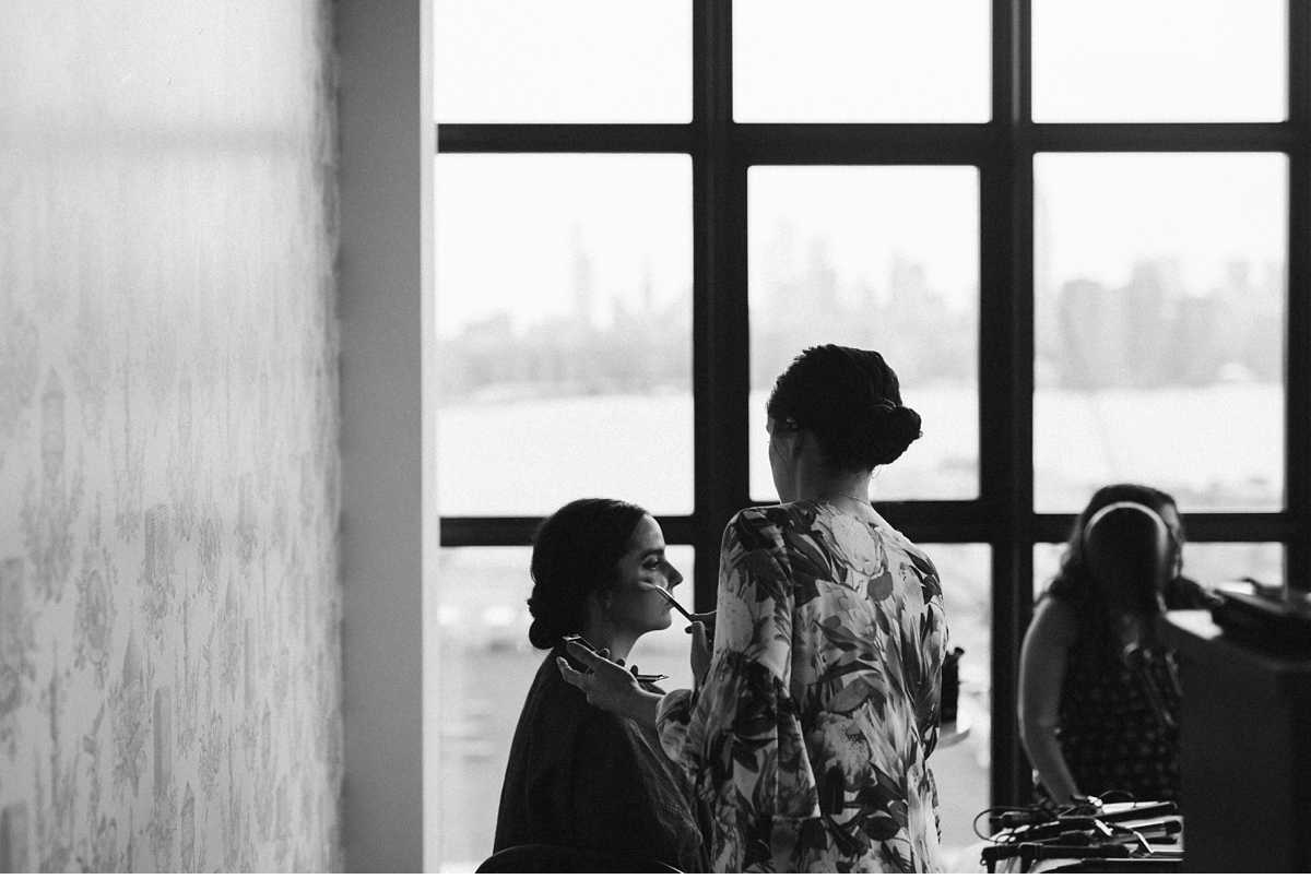 black and white photo of bride against window