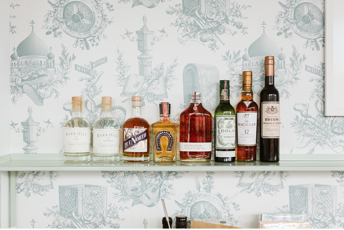 liquor bottles on shelf in hotel room at Wythe Hotel