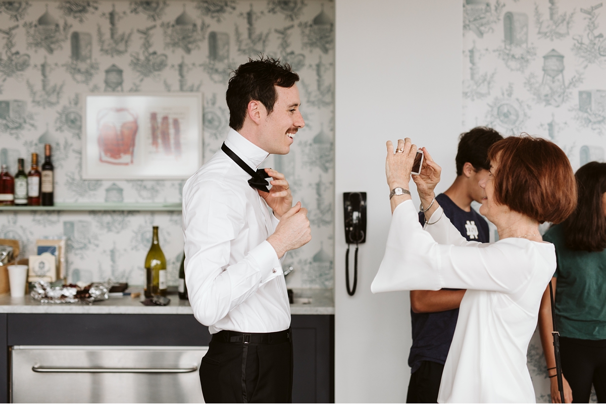 Aunt helping groom with his bow tie