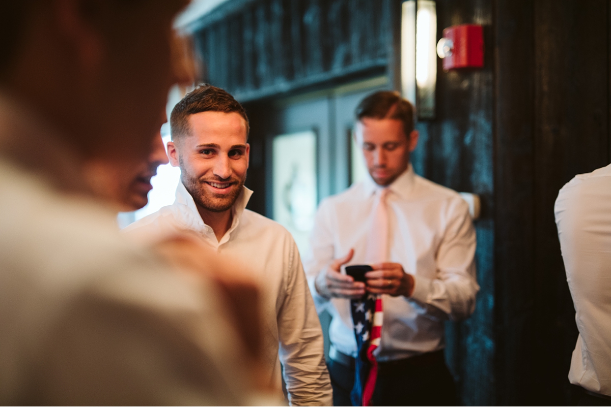 groomsman laughing at Oceanview of Nahant by Carl Heyerdahl Photography