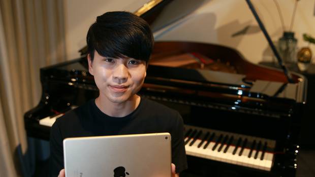 Jason Bae with a Steinway Spirio Piano which uses an iPad app to play like no piano you've ever heard - or seen - before. Photo / Doug Sherring