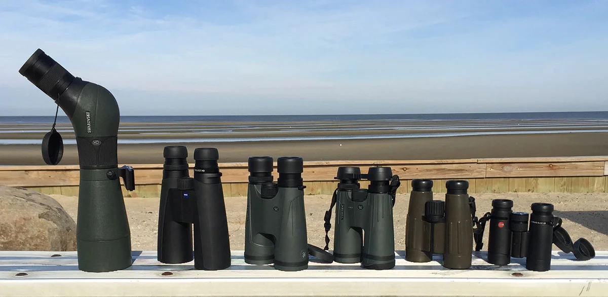 From left to right:   full-sized Swarovski 80HD scope (58 oz.), Zeiss 15x56 Conquest (46 oz.), Vortex 15x56 Kaibob (43 oz.), Vortex 15x50 Viper HD (28 oz.), Zeiss 7x42 Victory (26 oz.), and Leica 8x32 Utlravid HD (19 oz.).  