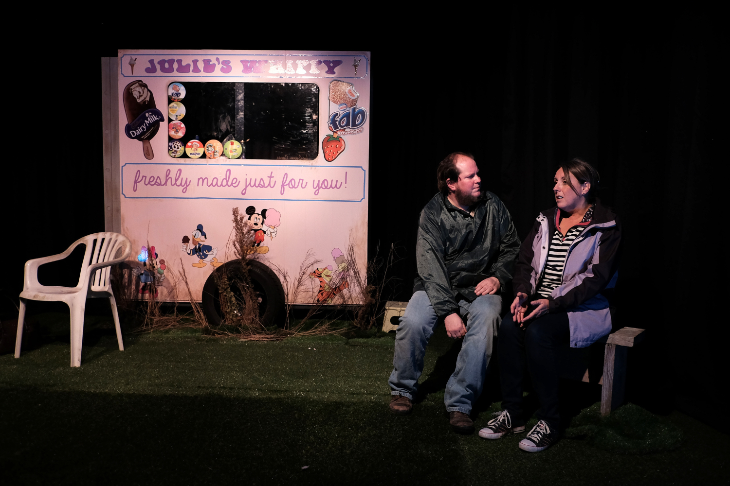 Actors performing in an intimate Green Room Productions theatre production, with audiences seated just a few feet from the stage.