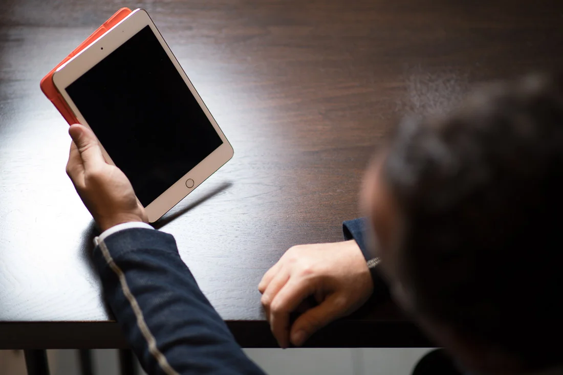 NYC Branded Lifestyle Portrait John Andrews looking at tablet
