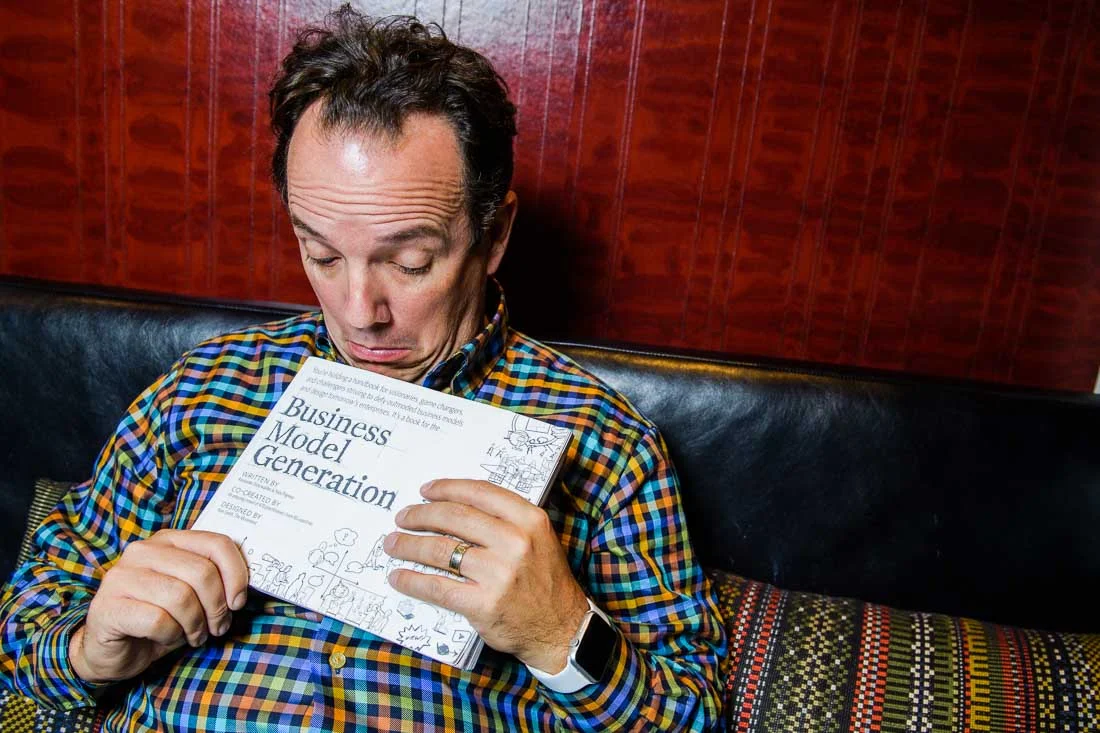 NYC Branded Lifestyle Portrait John Andrews being silly with book