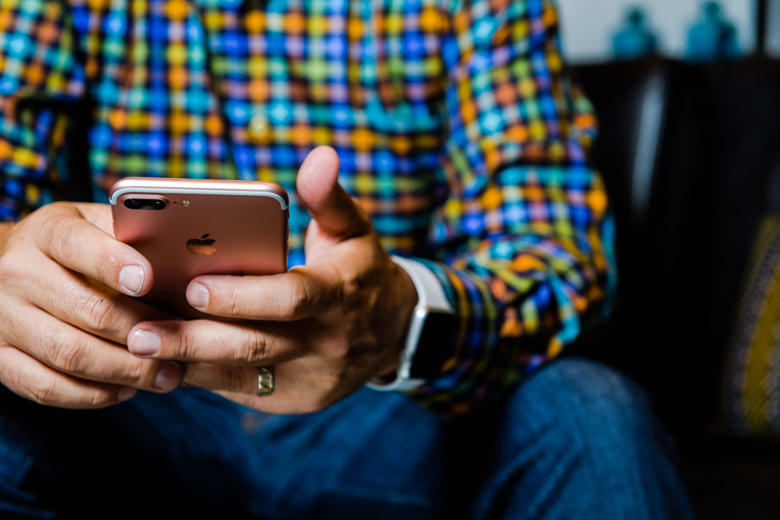 NYC Branded Lifestyle Portrait John Andrews typing on phone