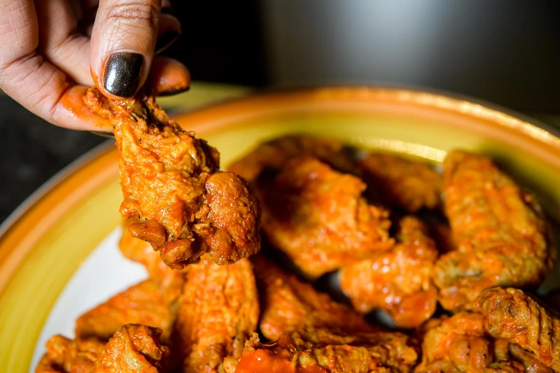 Branded Lifestyle Portrait chef author Daina Falk grabbing for wing