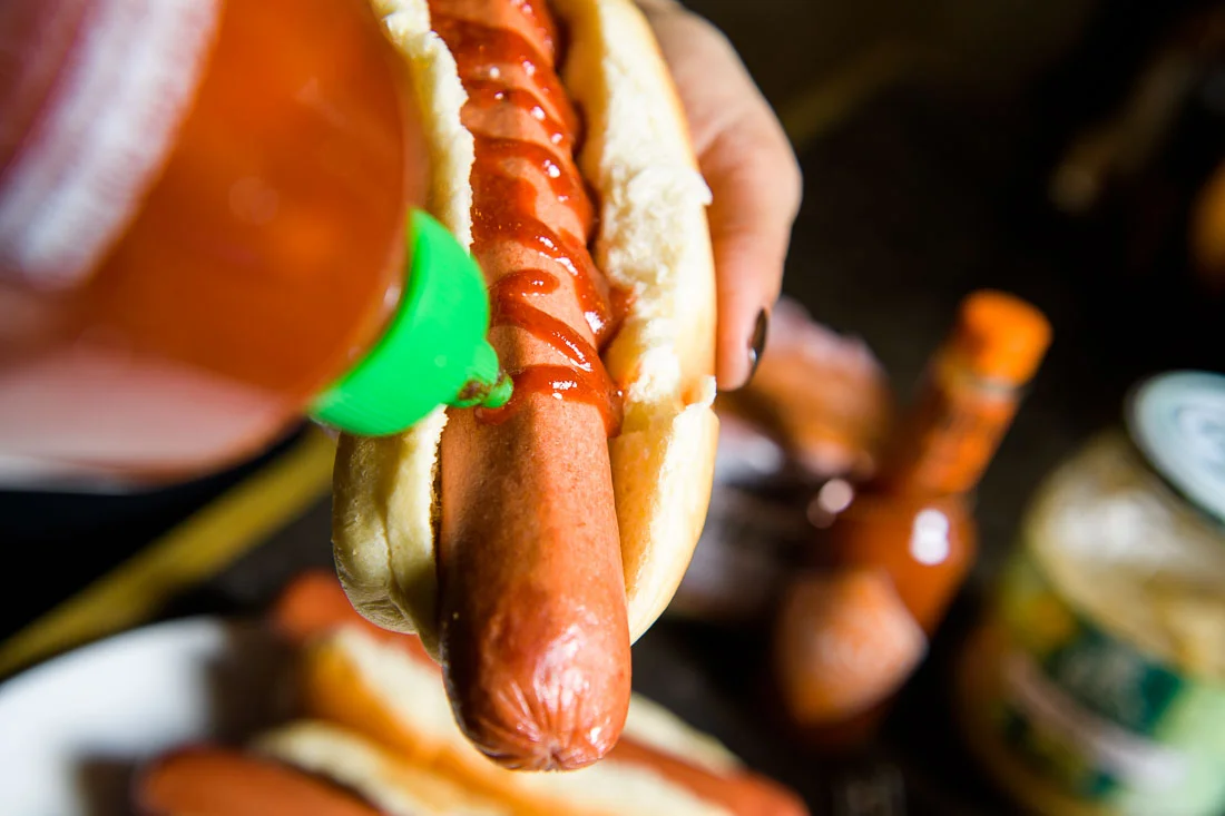 Branded Lifestyle Portrait chef author Daina Falk prepping hot dog