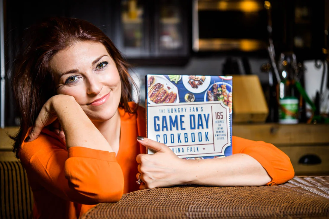 Branded Lifestyle Portrait chef author Daina Falk posing with her book