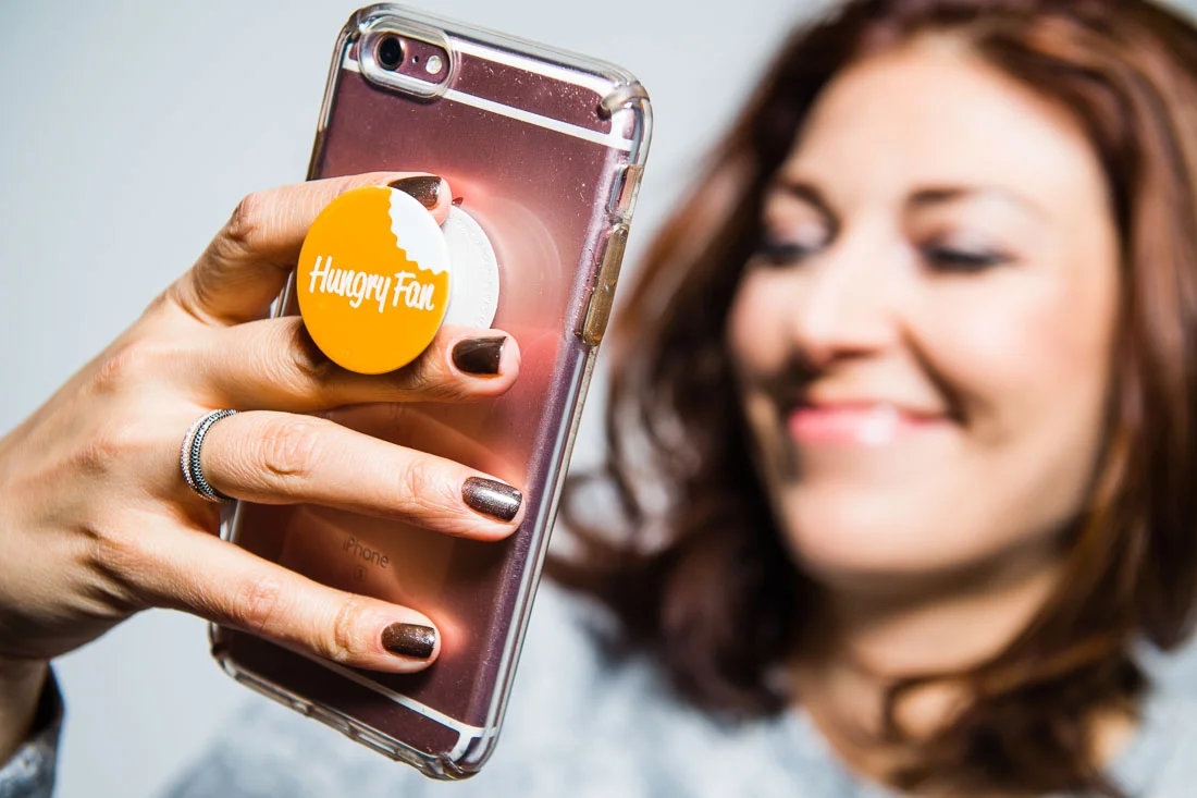 Branded Lifestyle Portrait chef author Daina Falk smiling while reading phone