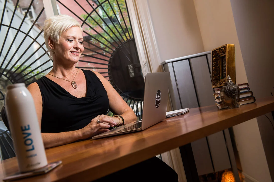 NYC Branded Lifestyle Portrait Speaker Coach Carolyn Herfurth working on laptop