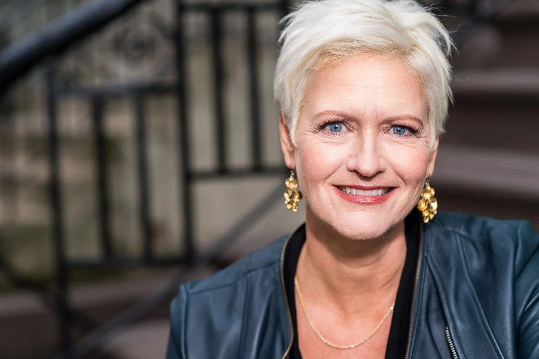 NYC Branded Lifestyle Portrait Speaker Coach Carolyn Herfurth headshot on stoop