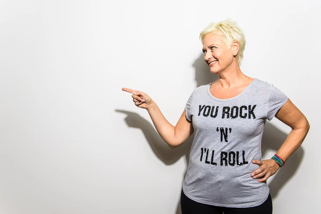 NYC Branded Lifestyle Portrait Speaker Coach Carolyn Herfurth pointing at something off camera