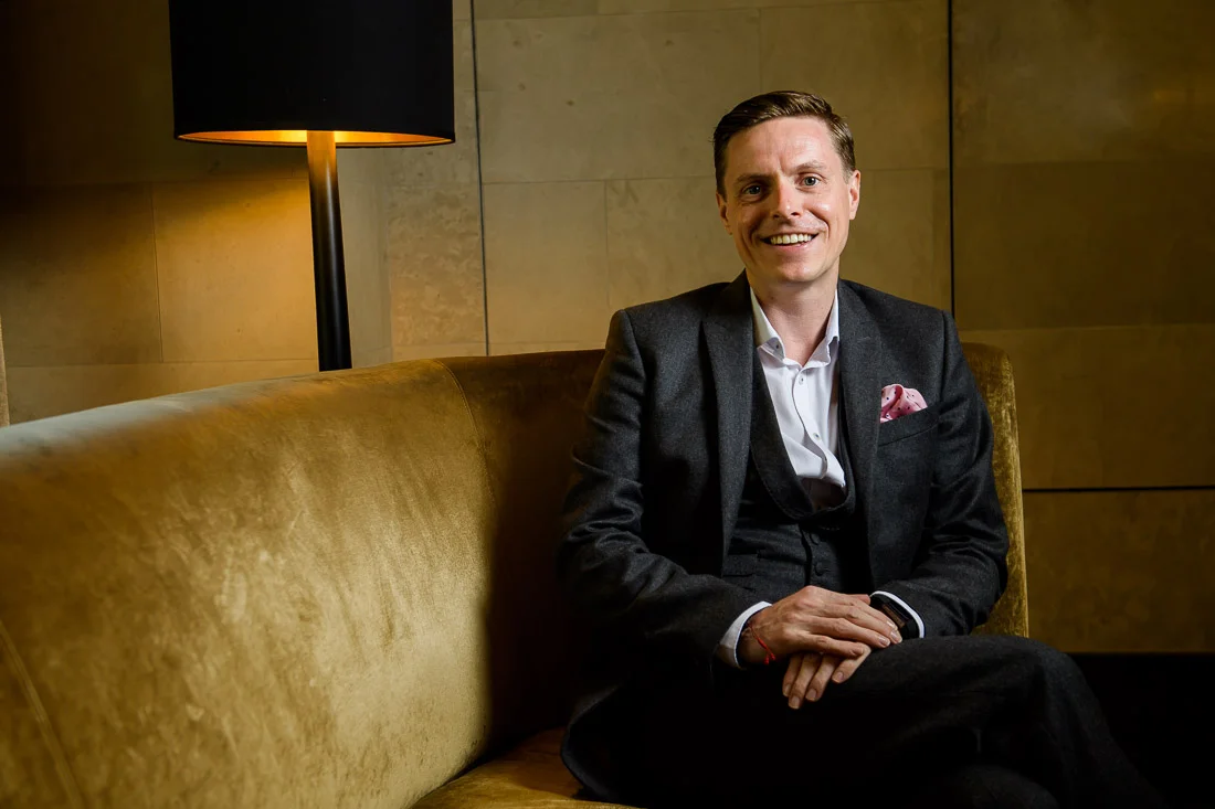 Branded Lifestyle Portrait Speaker Coach James Taylor on couch