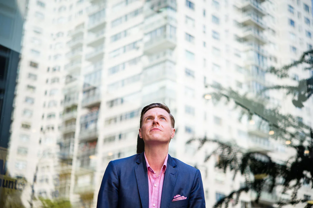 Branded Lifestyle Portrait Speaker Coach James Taylor  looking up at buildings