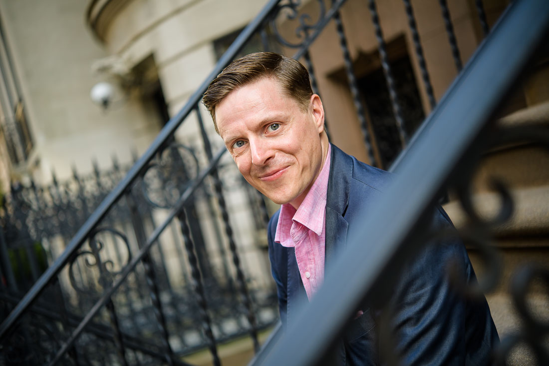 Branded Lifestyle Portrait Speaker Coach James Taylor sitting on stoop smiling