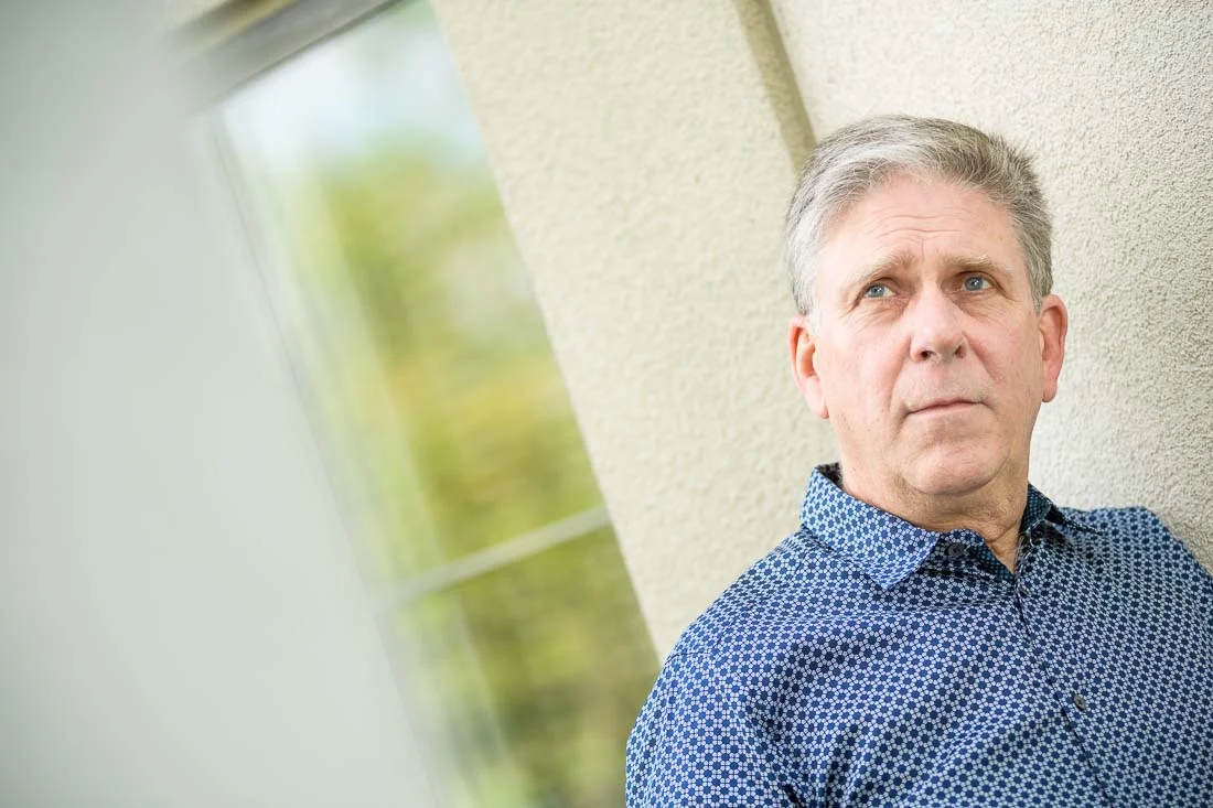 NYC Branded Lifestyle Portrait Randy Owens leaning on wall thinking