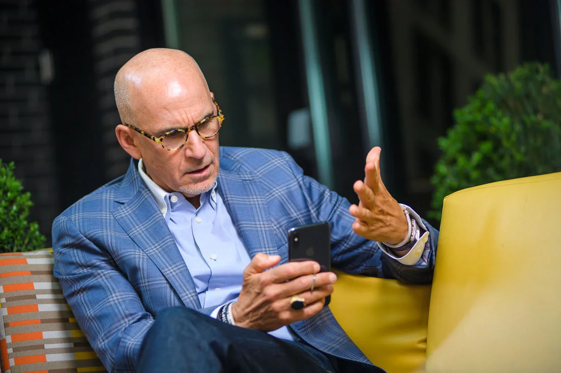 Thought leader Keynote Speaker Author Ted Rubin frustrated while reading phone