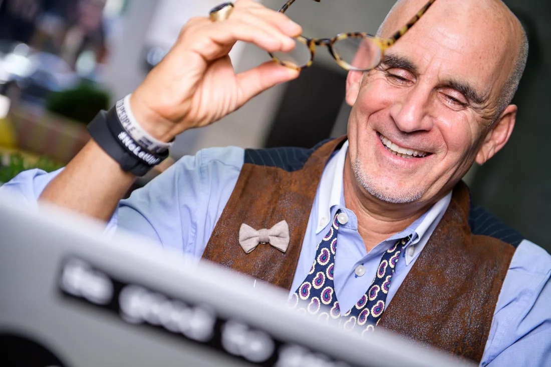 Thought leader Keynote Speaker Author Ted Rubin working on computer smiling