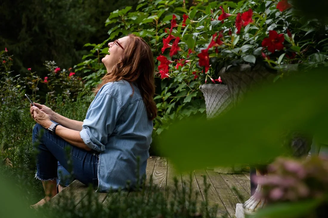 Strategic Social Photography Speaker Kate MacKinnon reading phone and laughing