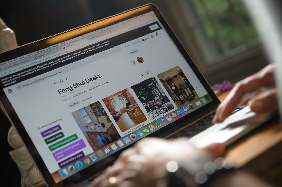 Strategic Social Photography Speaker Kate MacKinnon researching feng shui tables on laptop