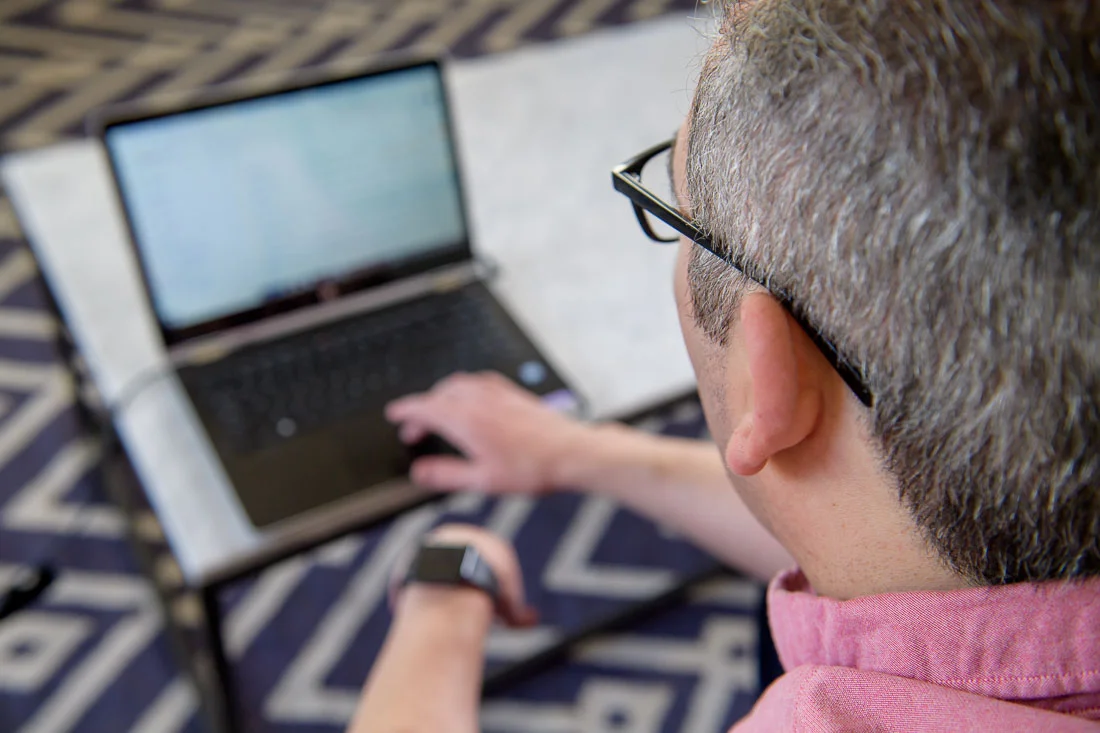 speaker connector thought leader Michael Roderick branded lifestyle portrait OTS on laptop