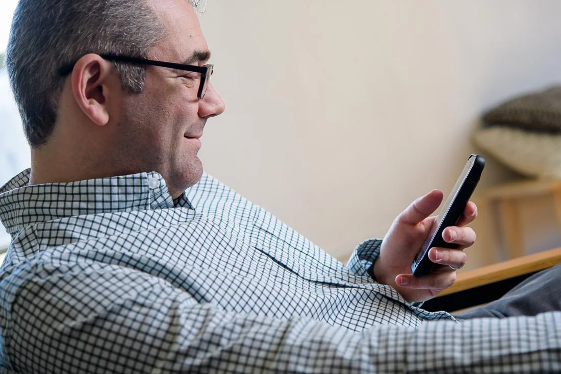 speaker connector thought leader Michael Roderick branded lifestyle portrait reading phone