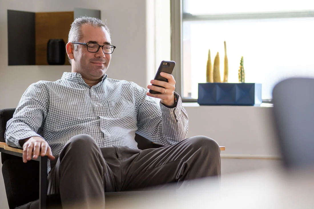 speaker connector thought leader Michael Roderick branded lifestyle portrait smiling while on phone