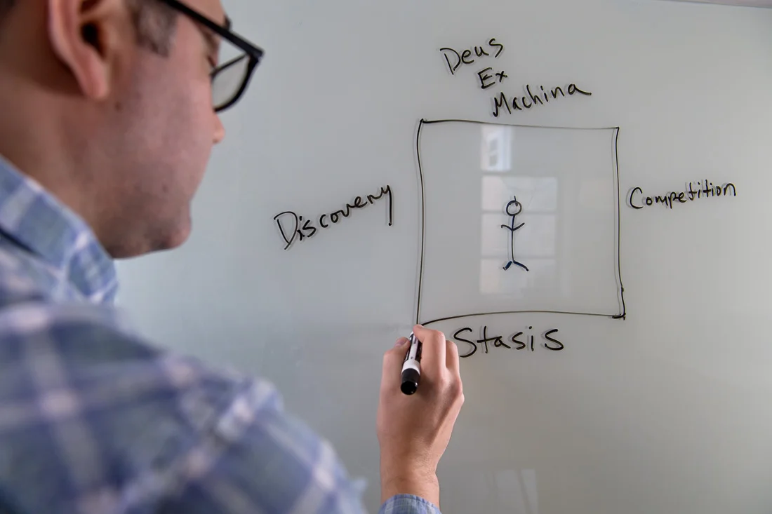 speaker connector thought leader Michael Roderick branded lifestyle portrait writing on whiteboard